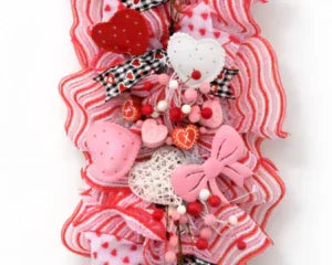 Handmade Valentine's Day wreath with pink hearts, red stripes, and bow accents for baby shower or memorial gifts