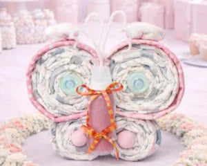 Handmade butterfly diaper cake with pastel colors and ribbon bow, perfect for baby showers