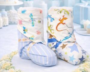 Handmade baby booties with colorful animal and star patterns, perfect for baby shower gifts or keepsakes.