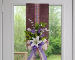 Purple and white floral wreath with ribbon, perfect for baby shower gifts or memorial keepsakes
