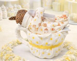 Handmade diaper cake centerpiece with yellow polka dots, perfect for baby showers or keepsake gifts.