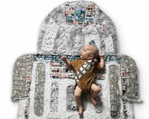 Baby in Chewbacca outfit on Star Wars-themed memory blanket with fabric patches