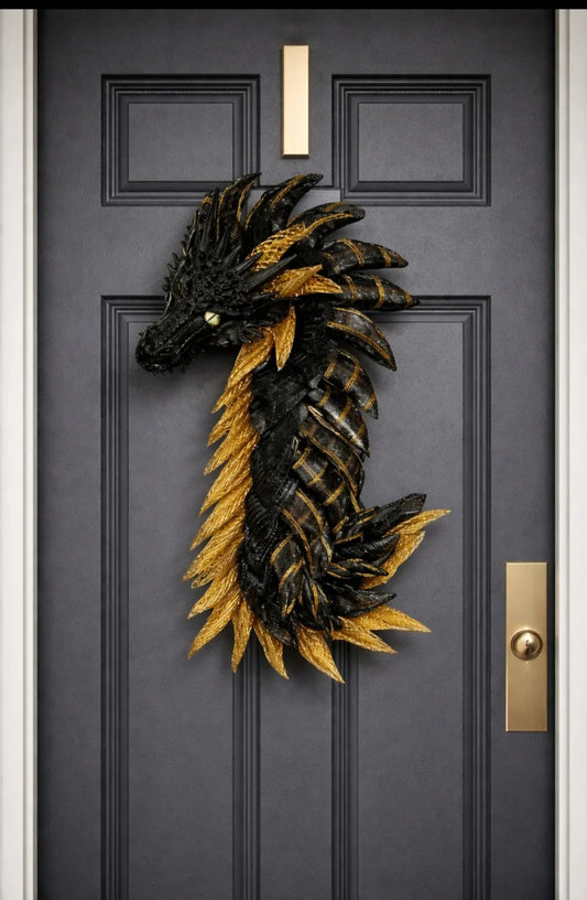 Black and gold dragon wreath hanging on a dark front door, perfect for fantasy-themed decor or unique home accents.