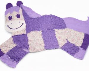 Purple and white patchwork memory blanket shaped like a smiling horse, handmade keepsake for baby or memorial
